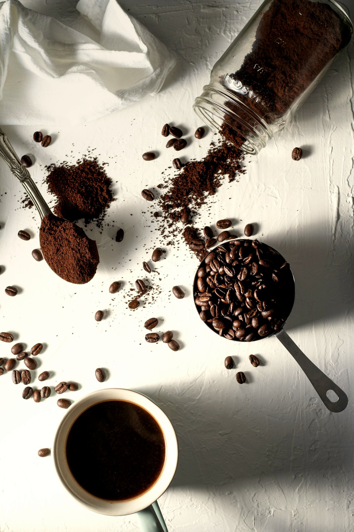 Coffee grounds and beans flat lay with a moka pot