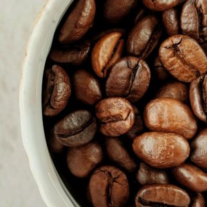 Yirgacheffe Gedeb coffee beans filling a white ceramic cupping cup