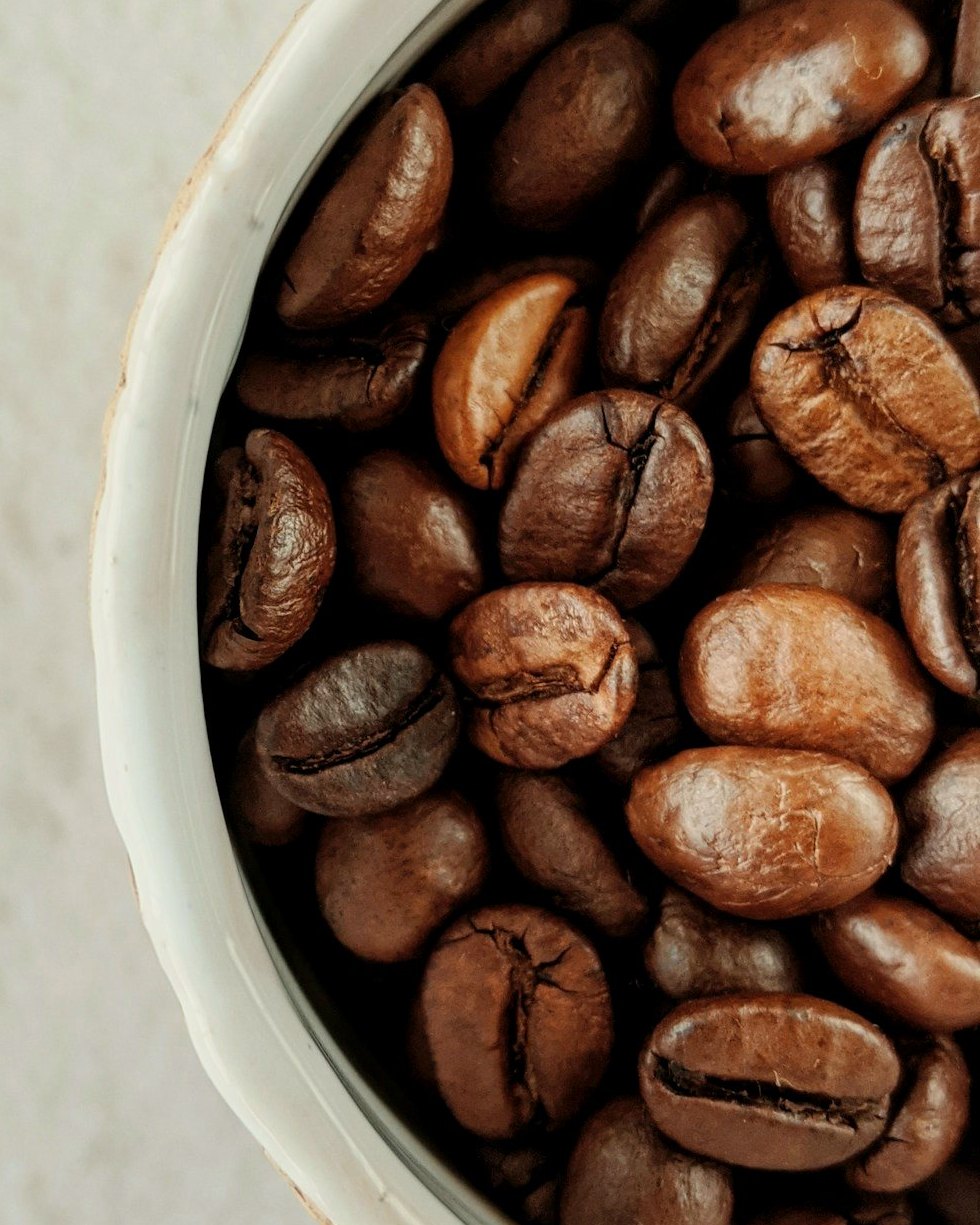 Yirgacheffe Gedeb coffee beans filling a white ceramic cupping cup